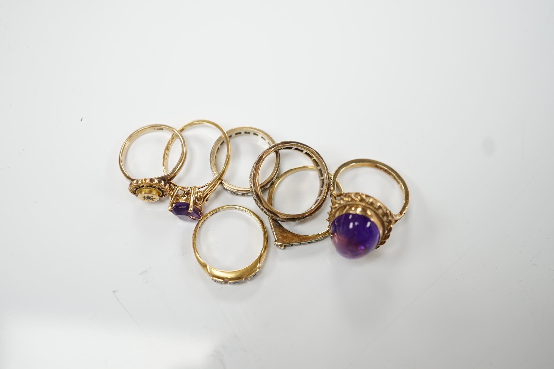 Five assorted 9ct and gems set rings including cabochon amethyst, gross weight 15.1 grams, an 18ct and gem set ring and a 585 emerald and diamond set ring